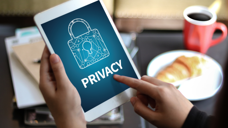 A person using a tablet displaying a padlock graphic and the word ‘Privacy.’
