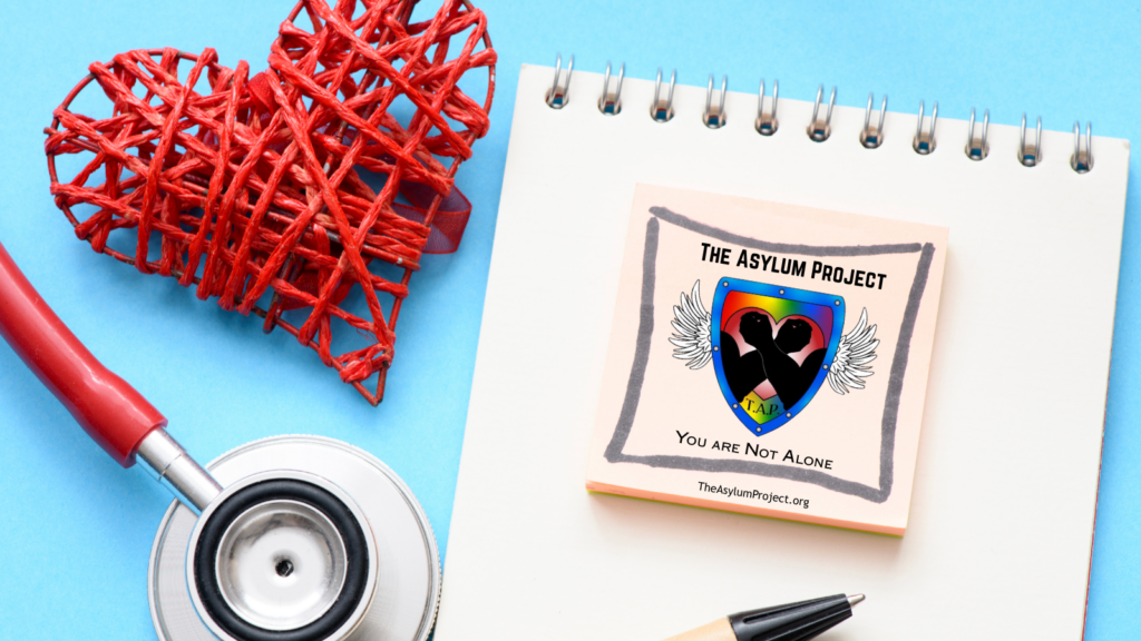 Red woven hearts and a stethoscope beside a notebook displaying The Asylum Project’s logo and the message “You Are Not Alone.”